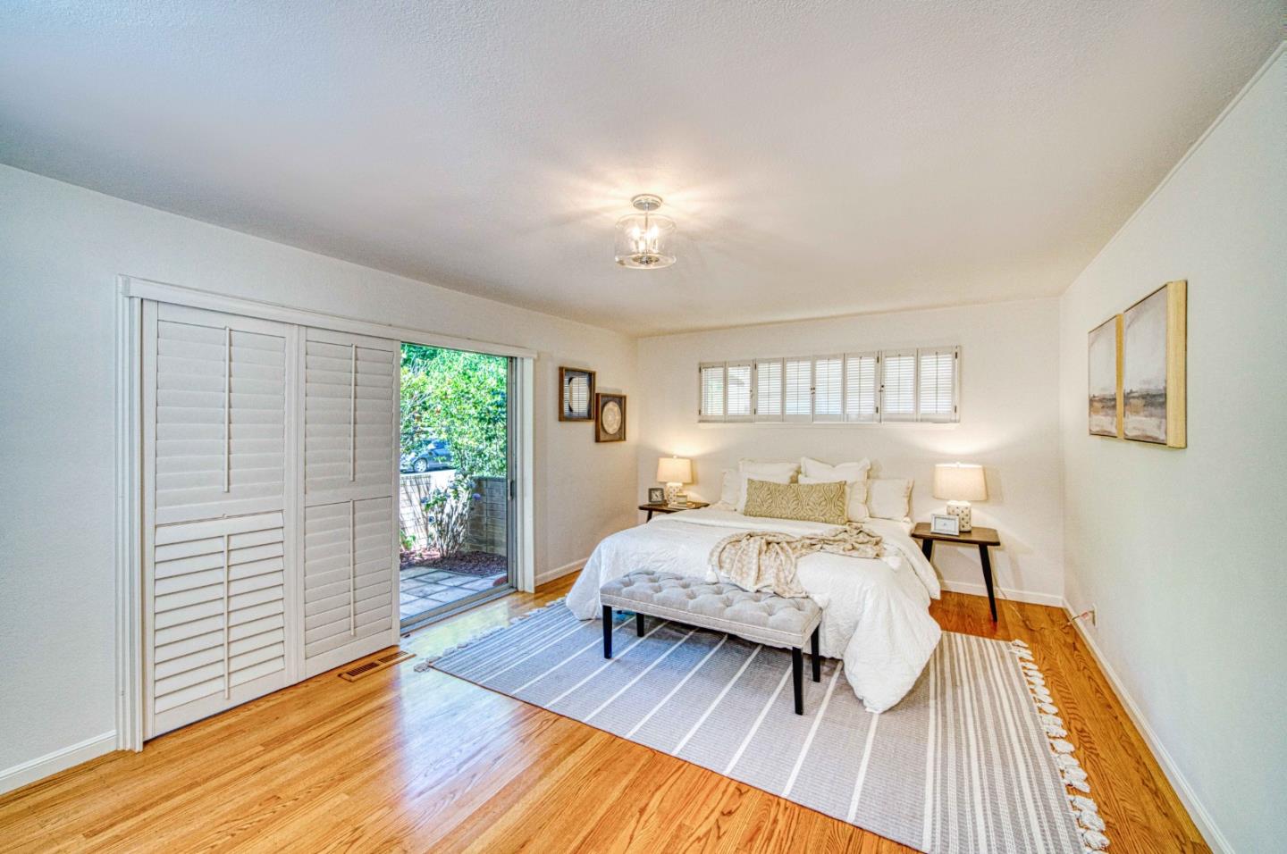 760 University Avenue Palo Alto, CA 94301 - Photo 14 of 25 a bedroom with a bed and wooden floor
