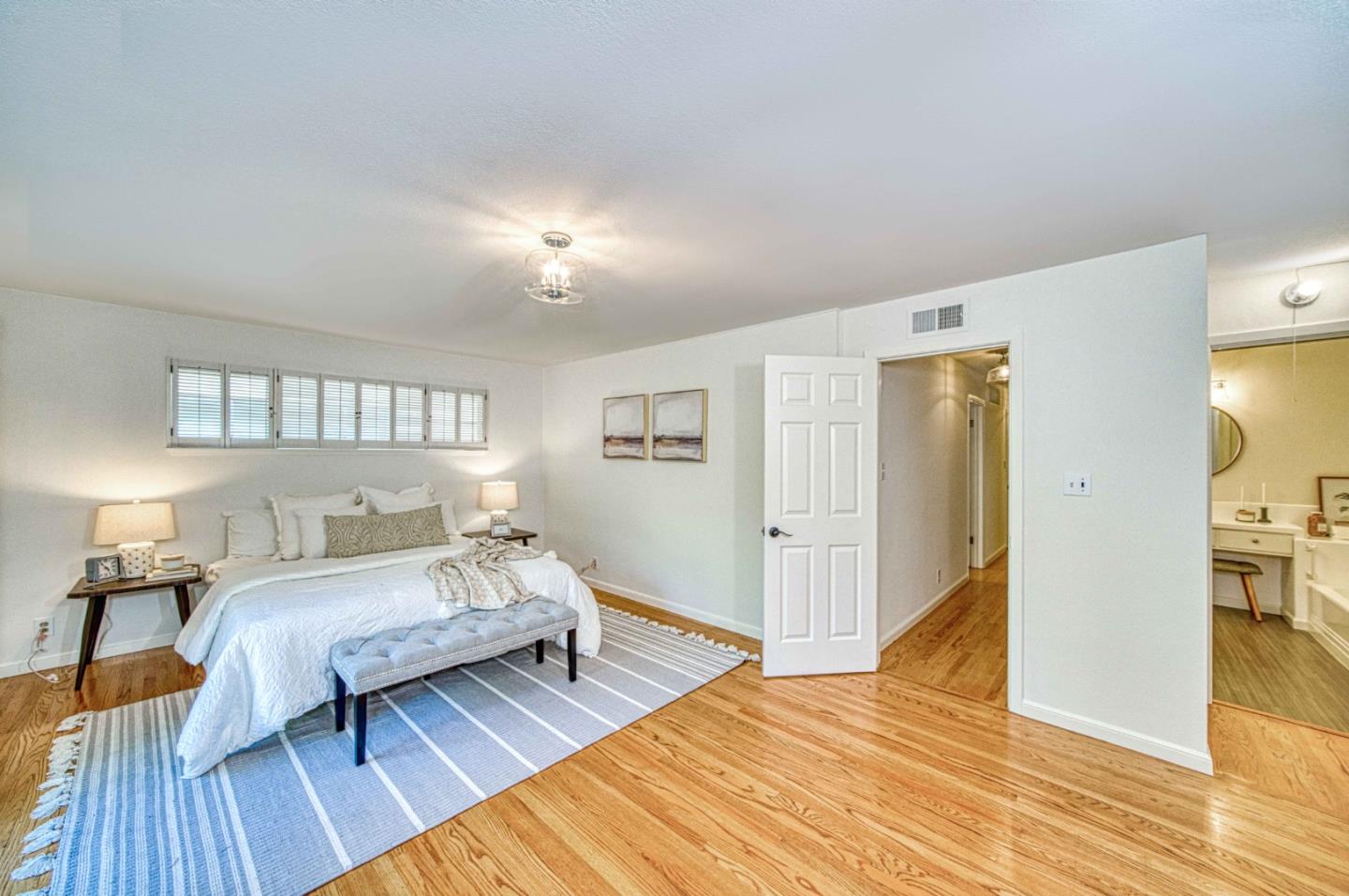760 University Avenue Palo Alto, CA 94301 - Photo 17 of 25 a bedroom with a bed and wooden floor