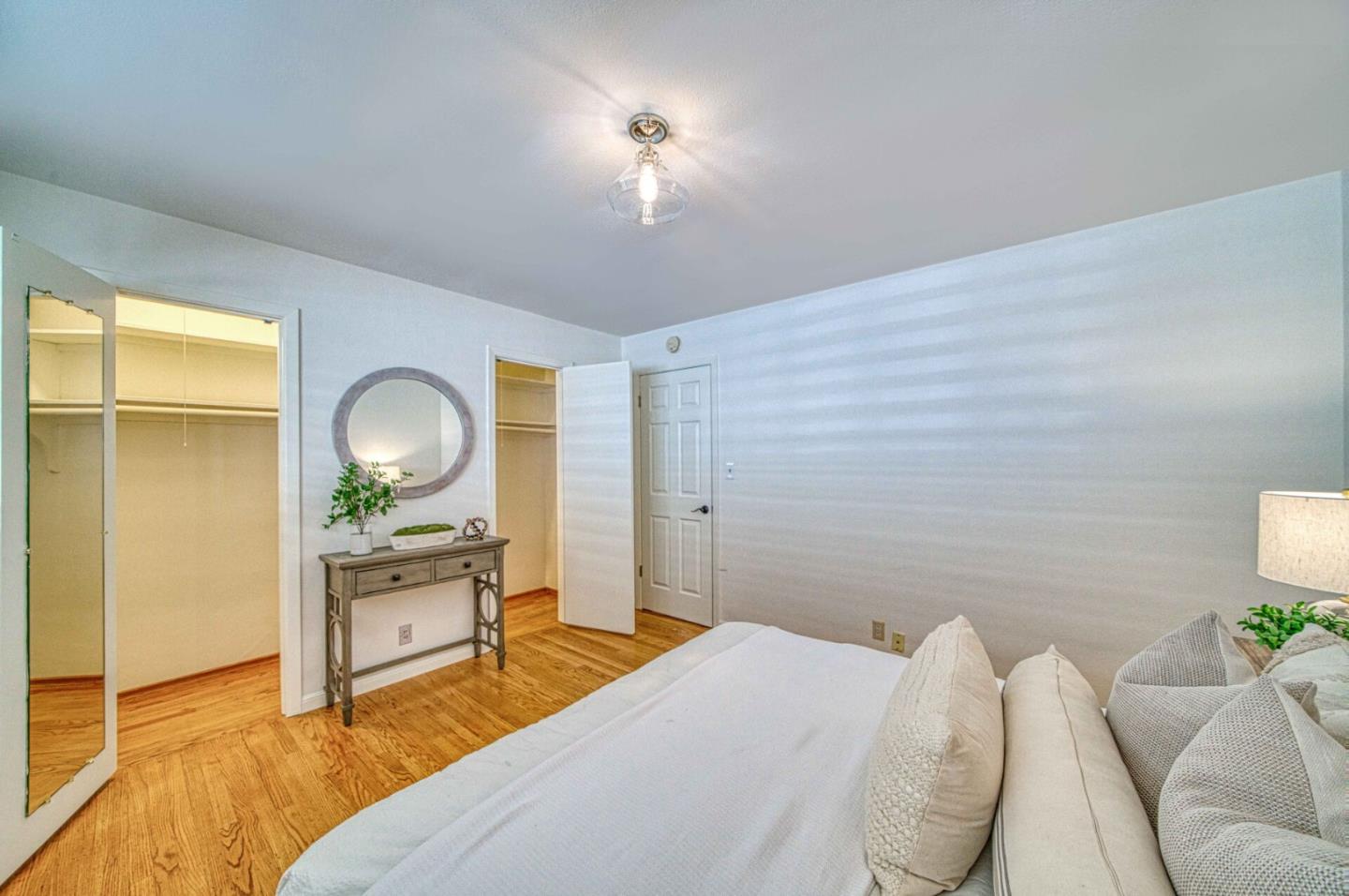 760 University Avenue Palo Alto, CA 94301 - Photo 19 of 25 a bedroom with a bed and wooden floor