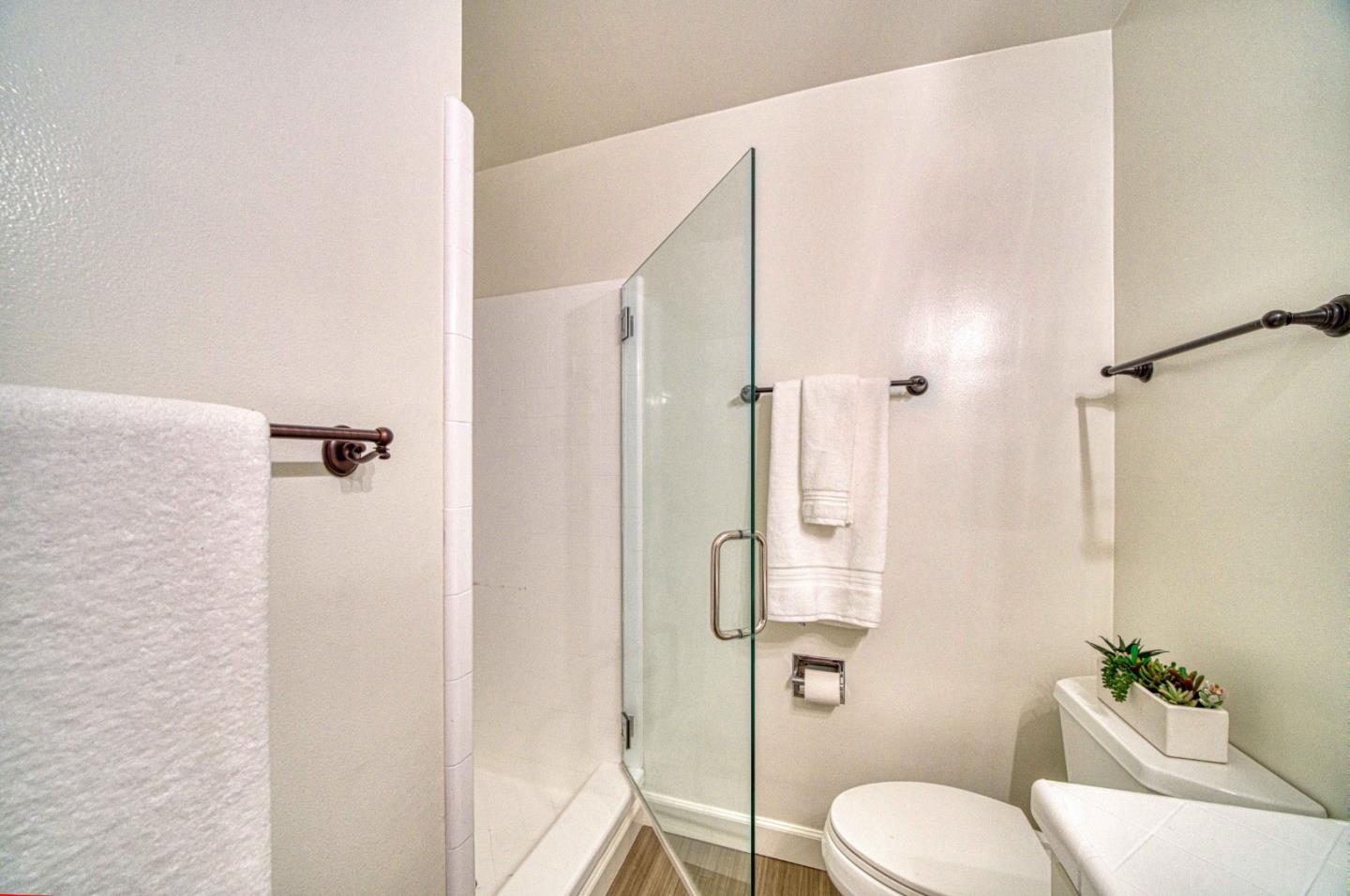 760 University Avenue Palo Alto, CA 94301 - Photo 21 of 25 a bathroom with a granite countertop shower and a toilet