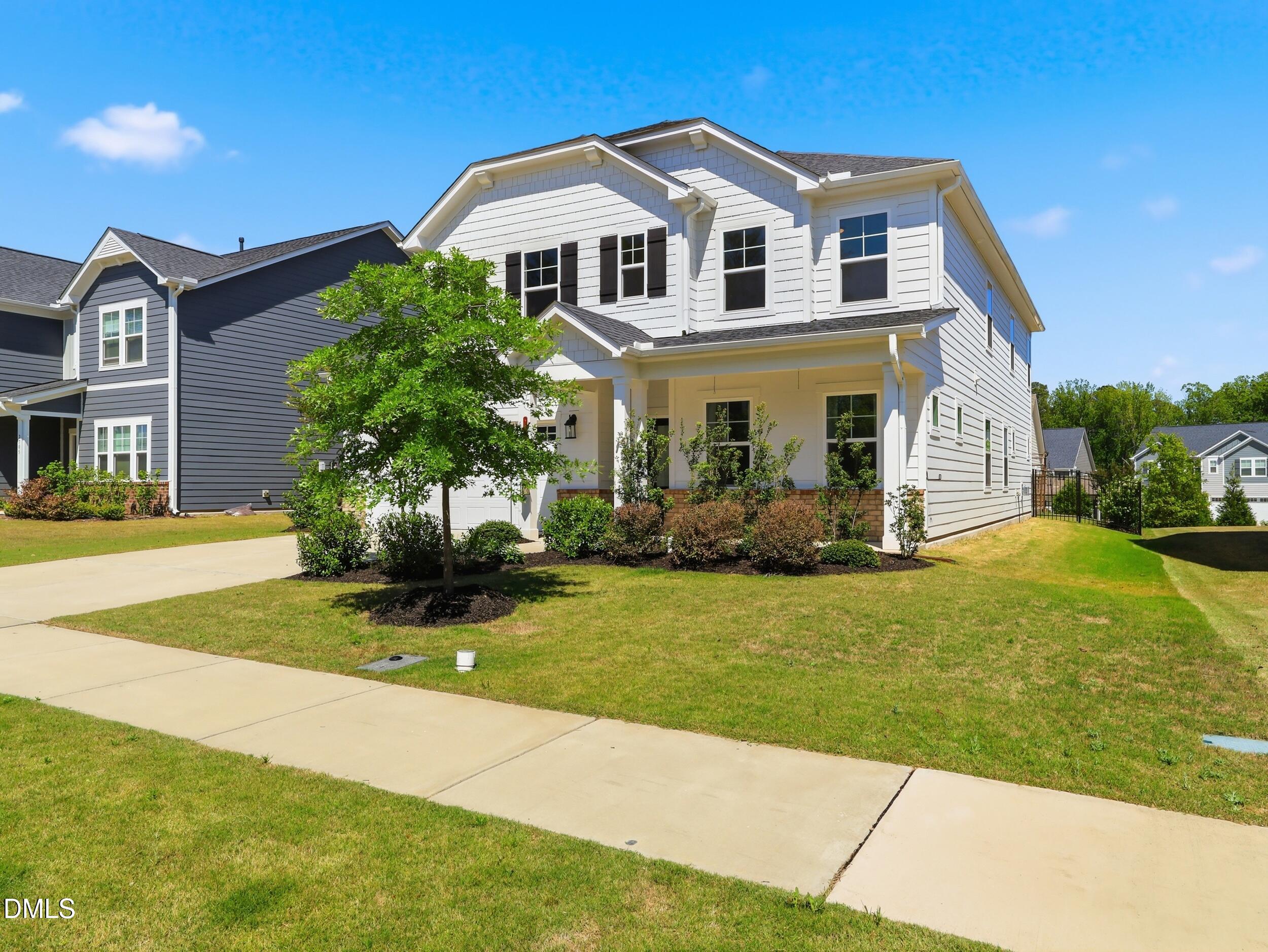 2709 Womble Ridge Drive New Hill, NC 27562 - Photo 3 of 60 a front view of a house with a yard