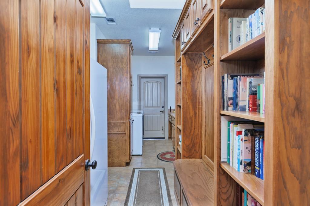 433 Fruitland Road Bowie, TX 76230 - Photo 11 of 40 a view of walk in closet with clothes and shoes