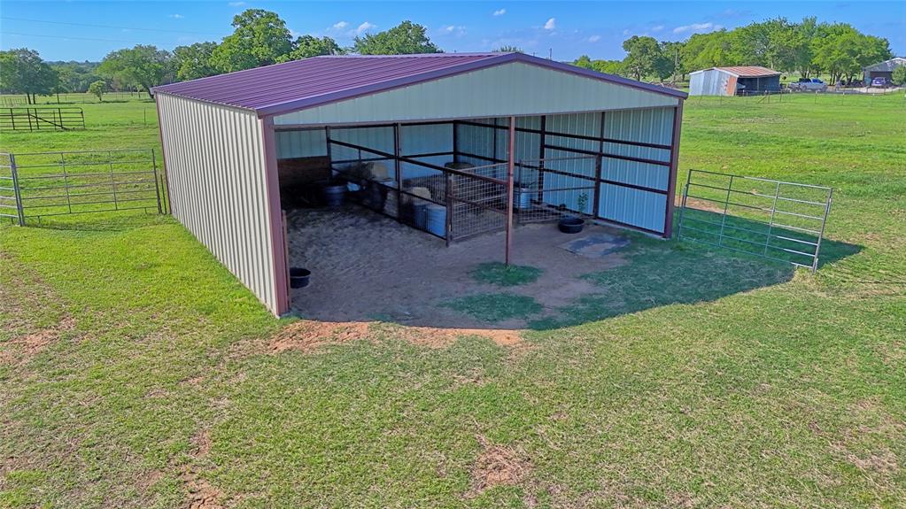 433 Fruitland Road Bowie, TX 76230 - Photo 12 of 40 a view of a house with a yard