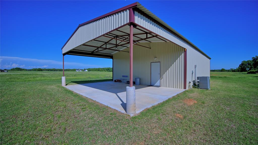 433 Fruitland Road Bowie, TX 76230 - Photo 15 of 40 a view of a house with a yard