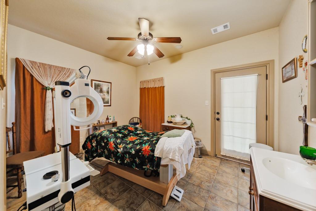 433 Fruitland Road Bowie, TX 76230 - Photo 16 of 40 a bedroom with bed and a mirror