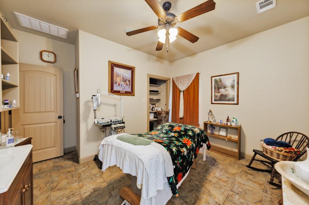 433 Fruitland Road Bowie, TX 76230 - Photo 18 of 40 a bedroom with a bed and furniture