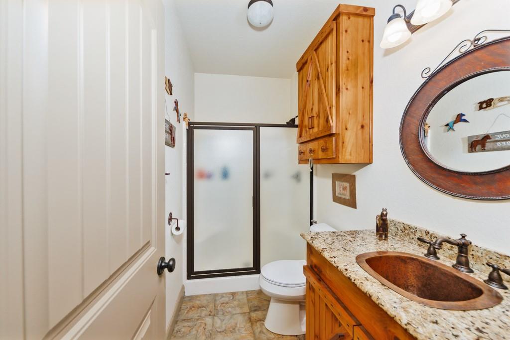 433 Fruitland Road Bowie, TX 76230 - Photo 19 of 40 a bathroom with a sink and a mirror