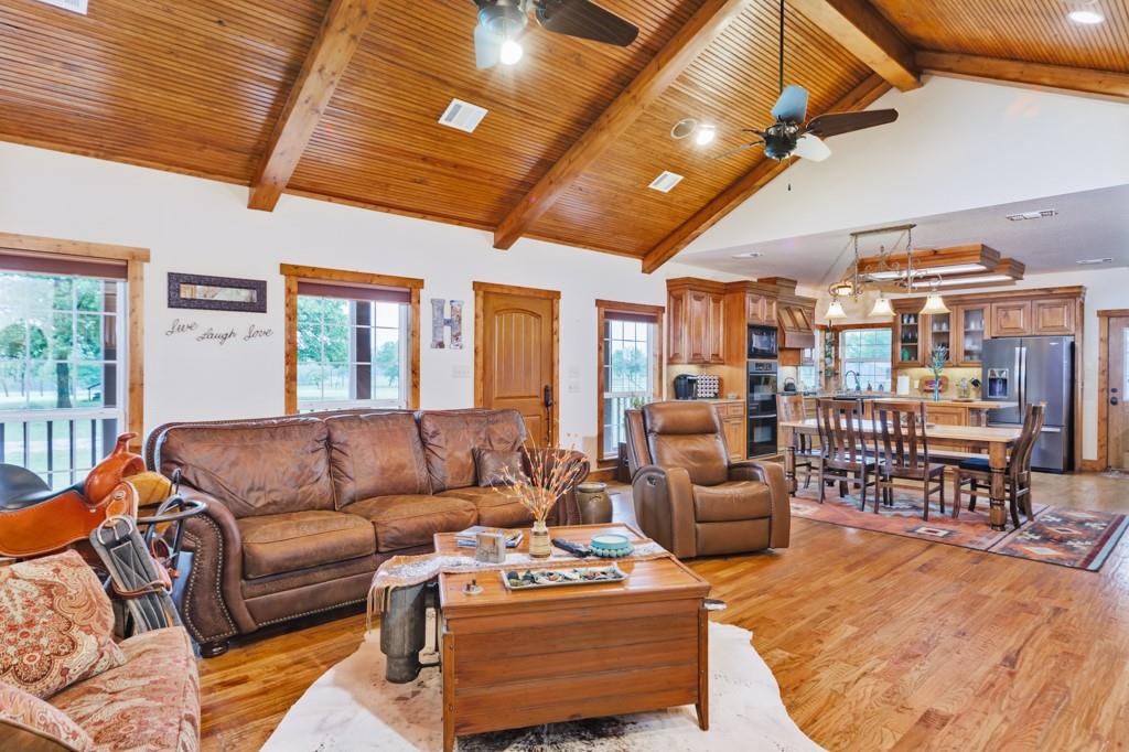 433 Fruitland Road Bowie, TX 76230 - Photo 2 of 40 a living room with furniture a ceiling fan and a rug