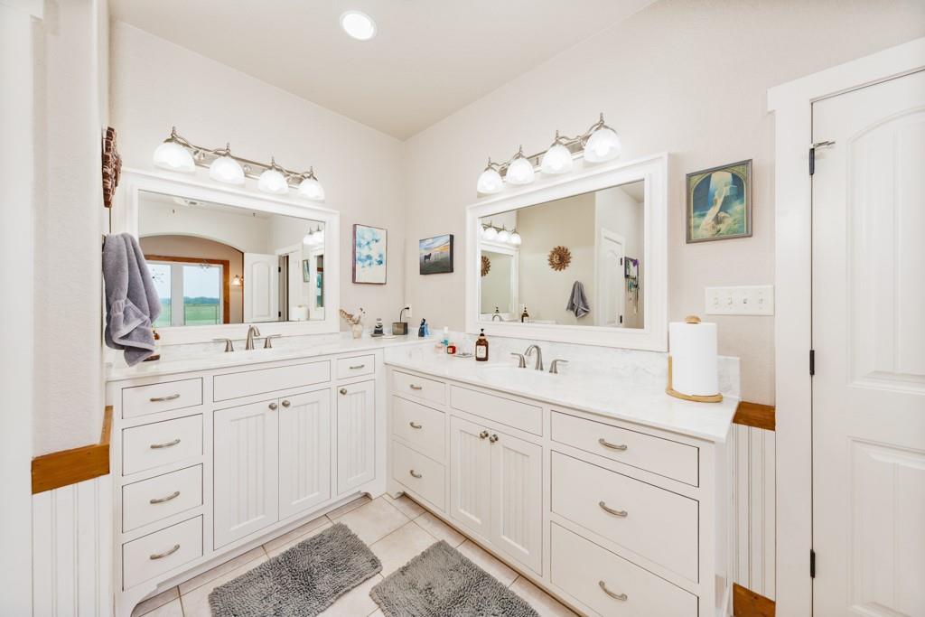 433 Fruitland Road Bowie, TX 76230 - Photo 23 of 40 a bathroom with a sink vanity and mirror