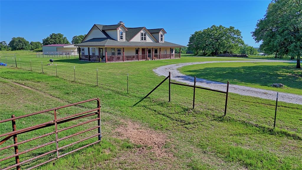 433 Fruitland Road Bowie, TX 76230 - Photo 37 of 40 a view of a house with a yard
