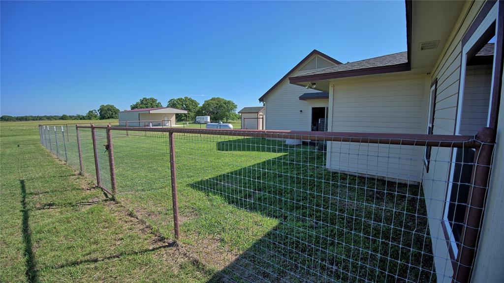 433 Fruitland Road Bowie, TX 76230 - Photo 39 of 40 a backyard of a house with lots of green space