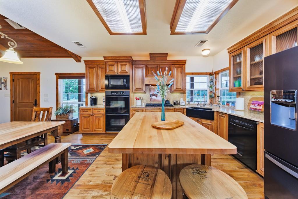 433 Fruitland Road Bowie, TX 76230 - Photo 8 of 40 a kitchen with a table and chairs in it
