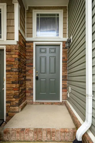 a view of a kitchen with refrigerator and windows