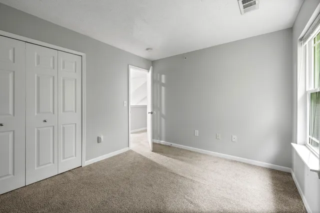 a front view of a house with a garden and yard