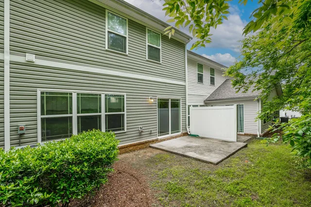 a view of a house with backyard and sitting area