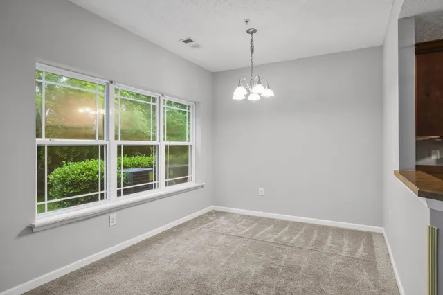 a living room with furniture a rug and a window