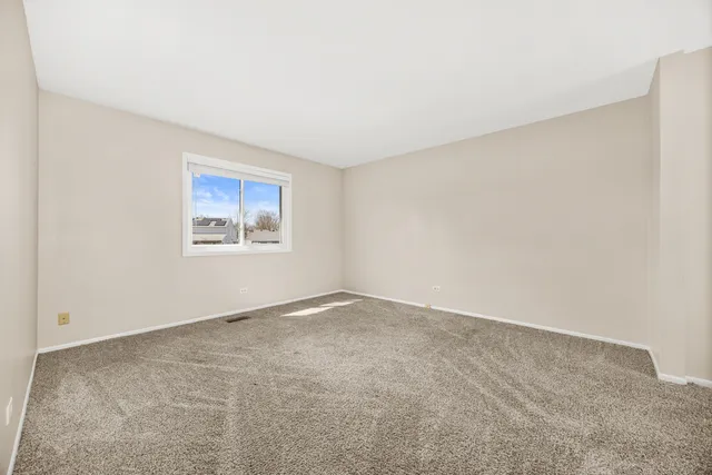 an empty room with a empty space and window