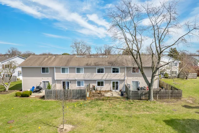 a view of a house with a yard patio and fire pit