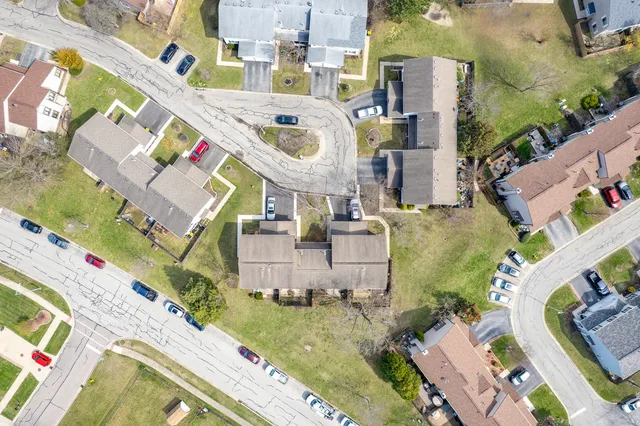 an aerial view of residential houses with outdoor space