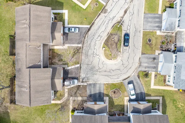 an aerial view of multi story residential apartment building with swimming pool