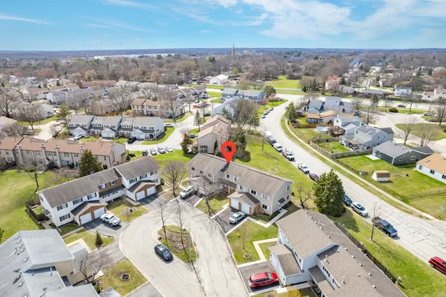 an aerial view of a swimming pool with outdoor seating