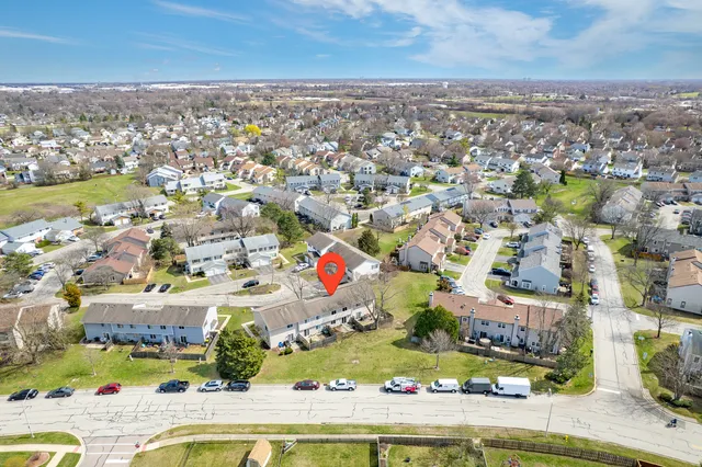 an aerial view of residential houses with outdoor space and swimming pool