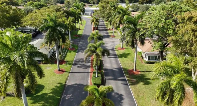 an aerial view of a house with swimming pool patio and outdoor seating