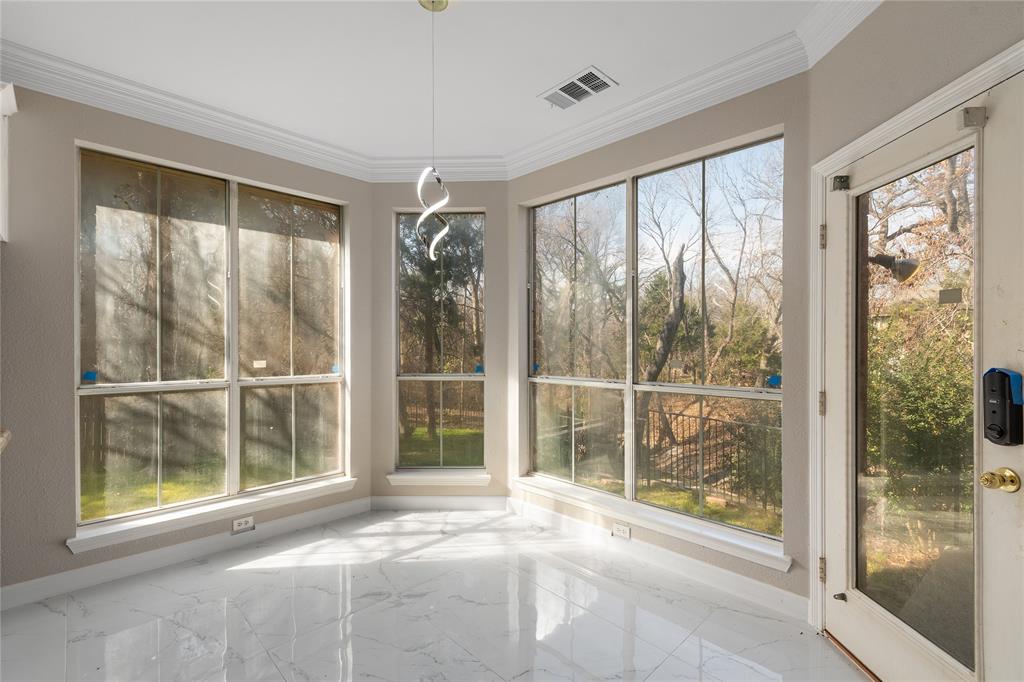 225 Freedom Court Rockwall, TX 75032 - Photo 12 of 28 a view of an empty room with wooden floor and a window