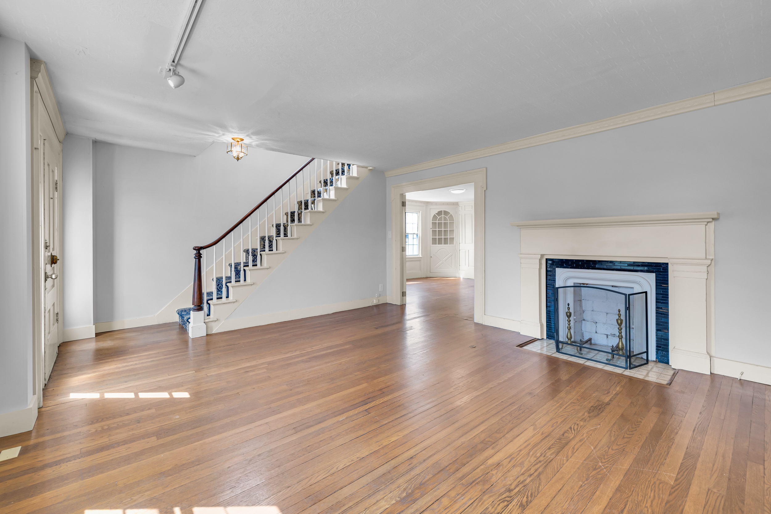 1070 Enfield Street Enfield, CT 06082 - Photo 13 of 35 a view of an empty room with wooden floor fireplace and a window
