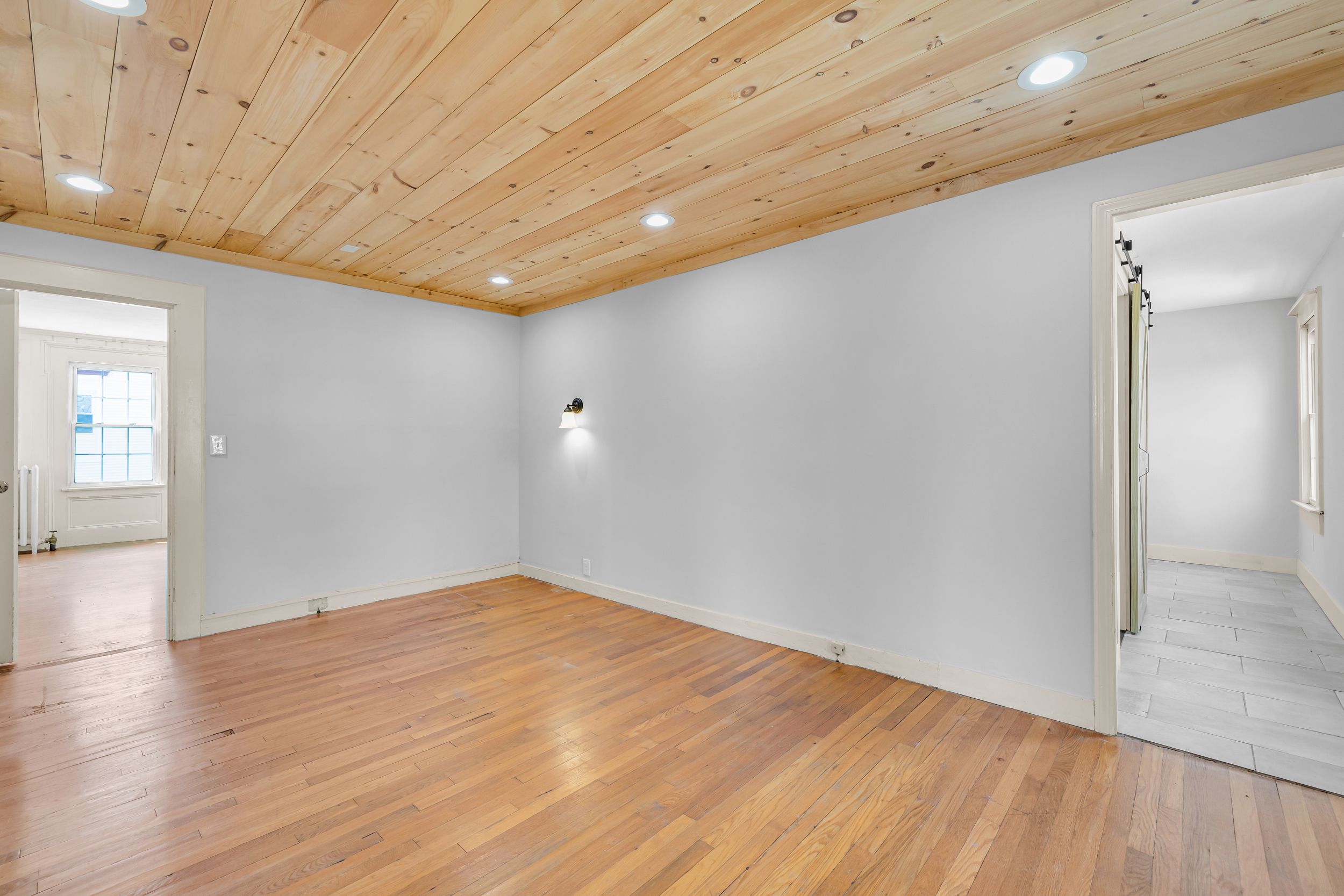 1070 Enfield Street Enfield, CT 06082 - Photo 15 of 35 wooden floor in an empty room with a window
