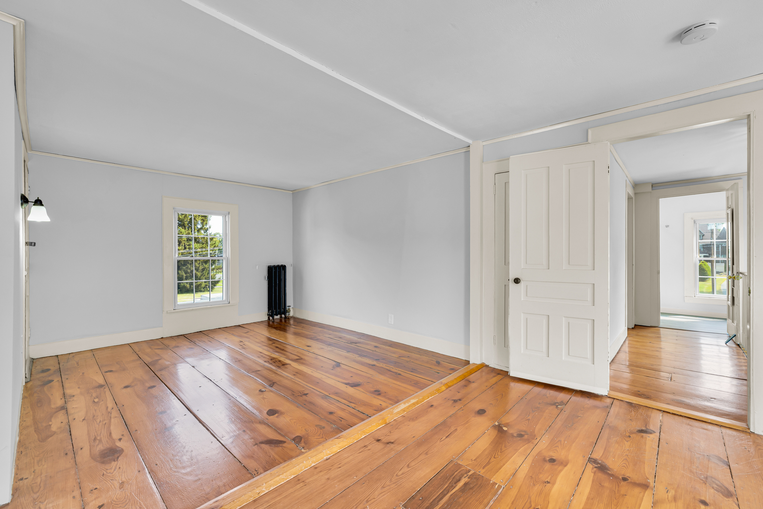 1070 Enfield Street Enfield, CT 06082 - Photo 23 of 35 a view of an empty room with wooden floor and a window