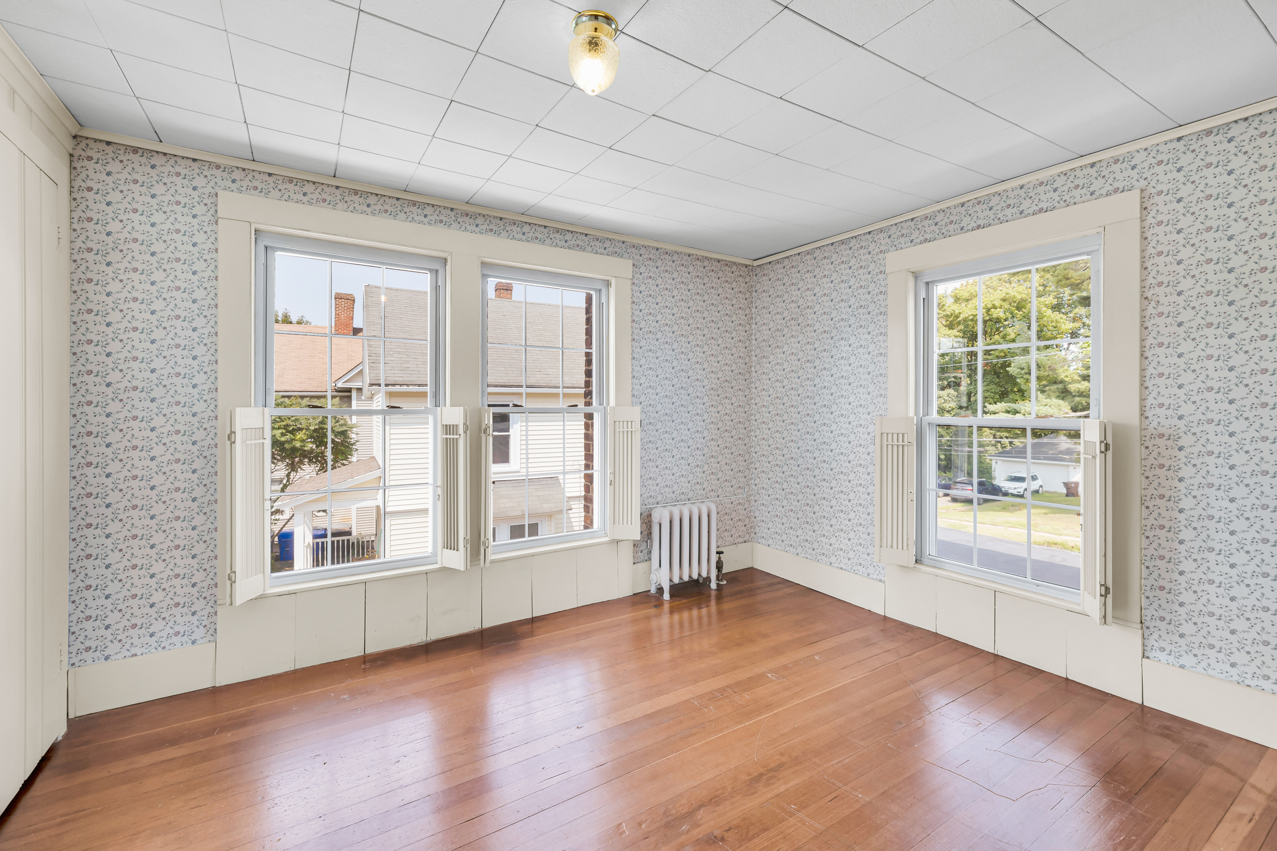 1070 Enfield Street Enfield, CT 06082 - Photo 24 of 35 an empty room with wooden floor and windows