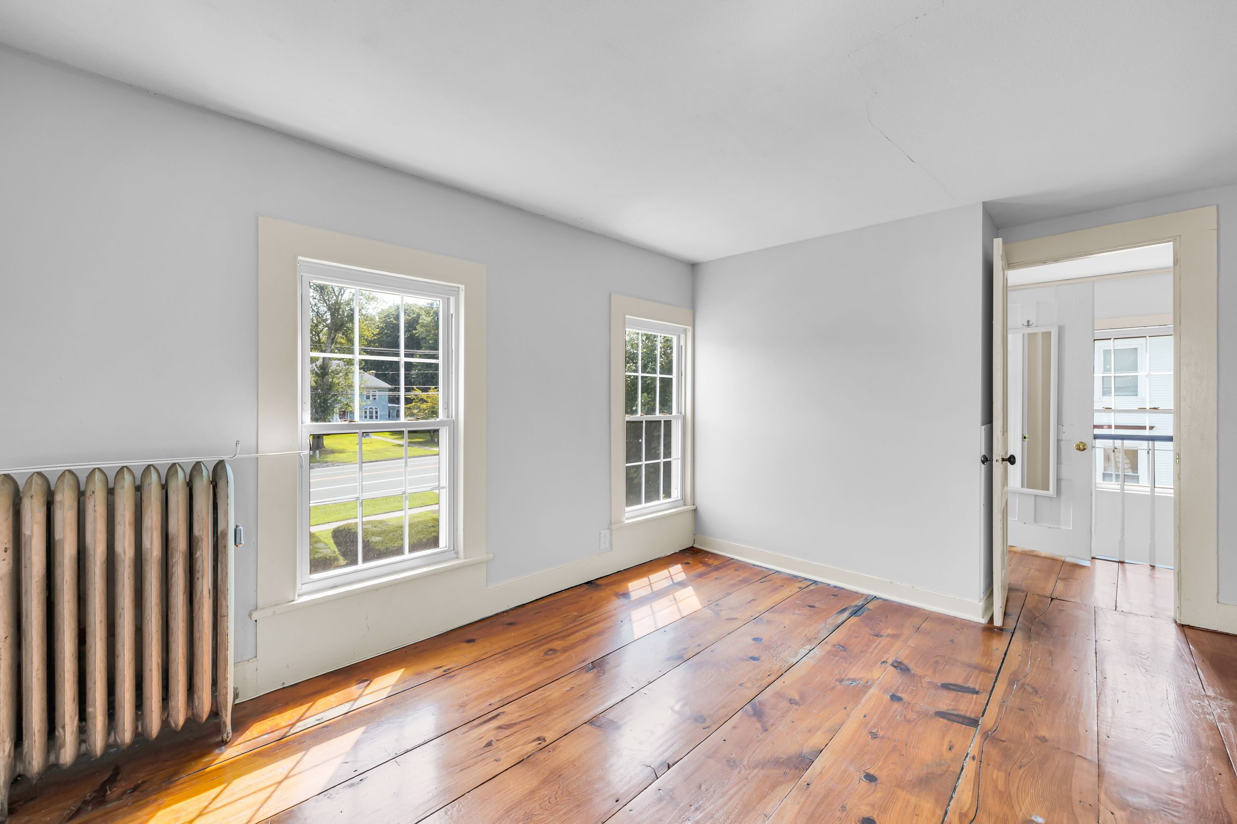 1070 Enfield Street Enfield, CT 06082 - Photo 28 of 35 wooden floor in an empty room with a window