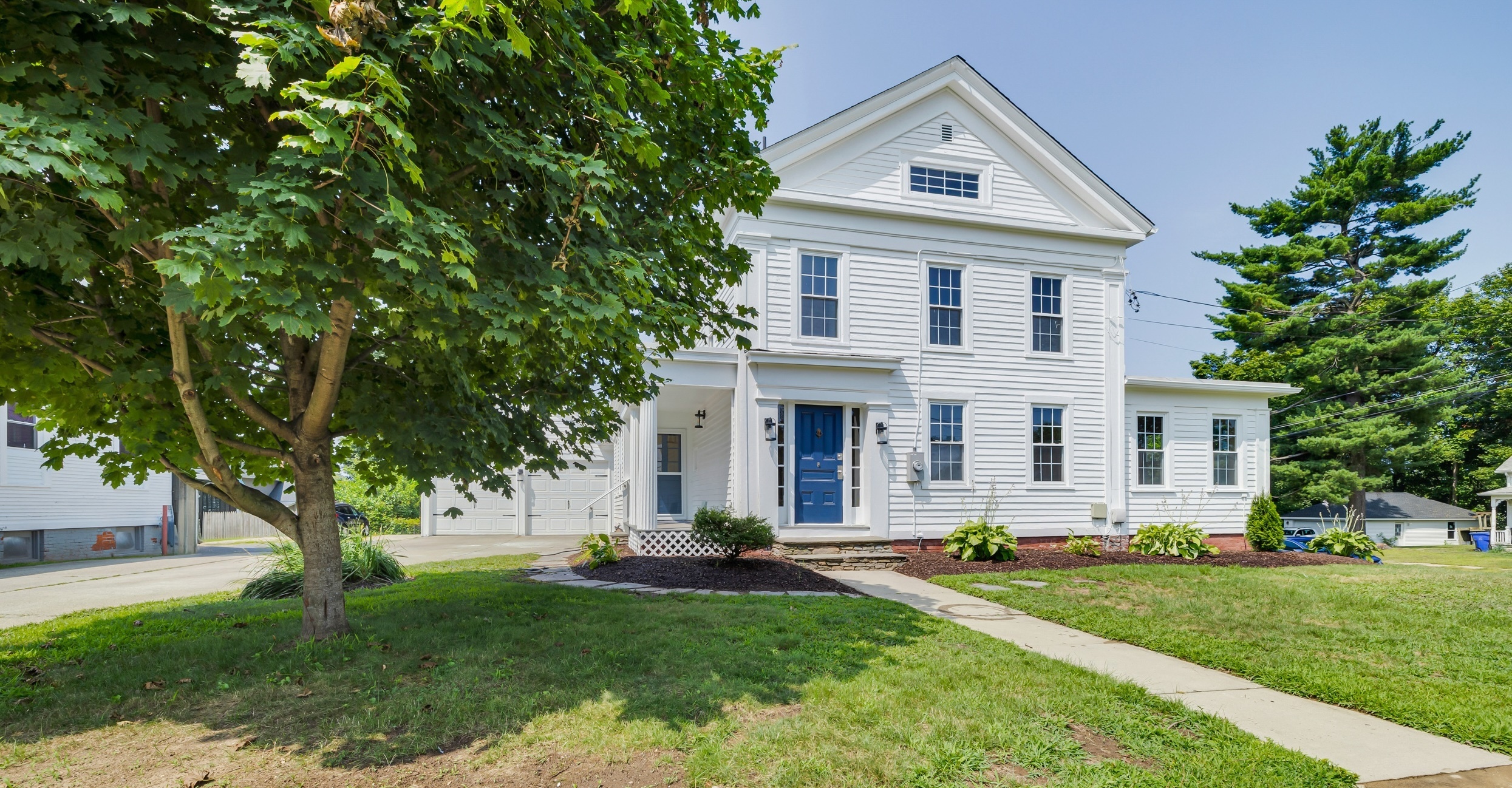 1070 Enfield Street Enfield, CT 06082 - Photo 30 of 35 a front view of a house with a yard and trees
