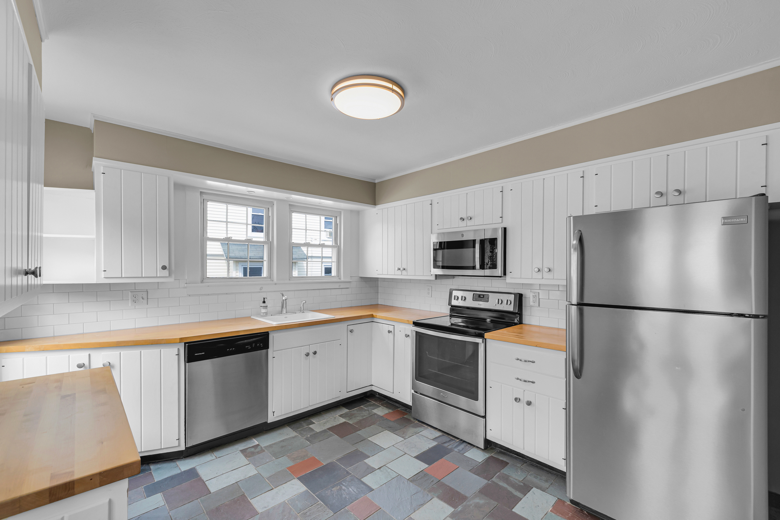 1070 Enfield Street Enfield, CT 06082 - Photo 3 of 35 a kitchen with granite countertop appliances a sink and a refrigerator