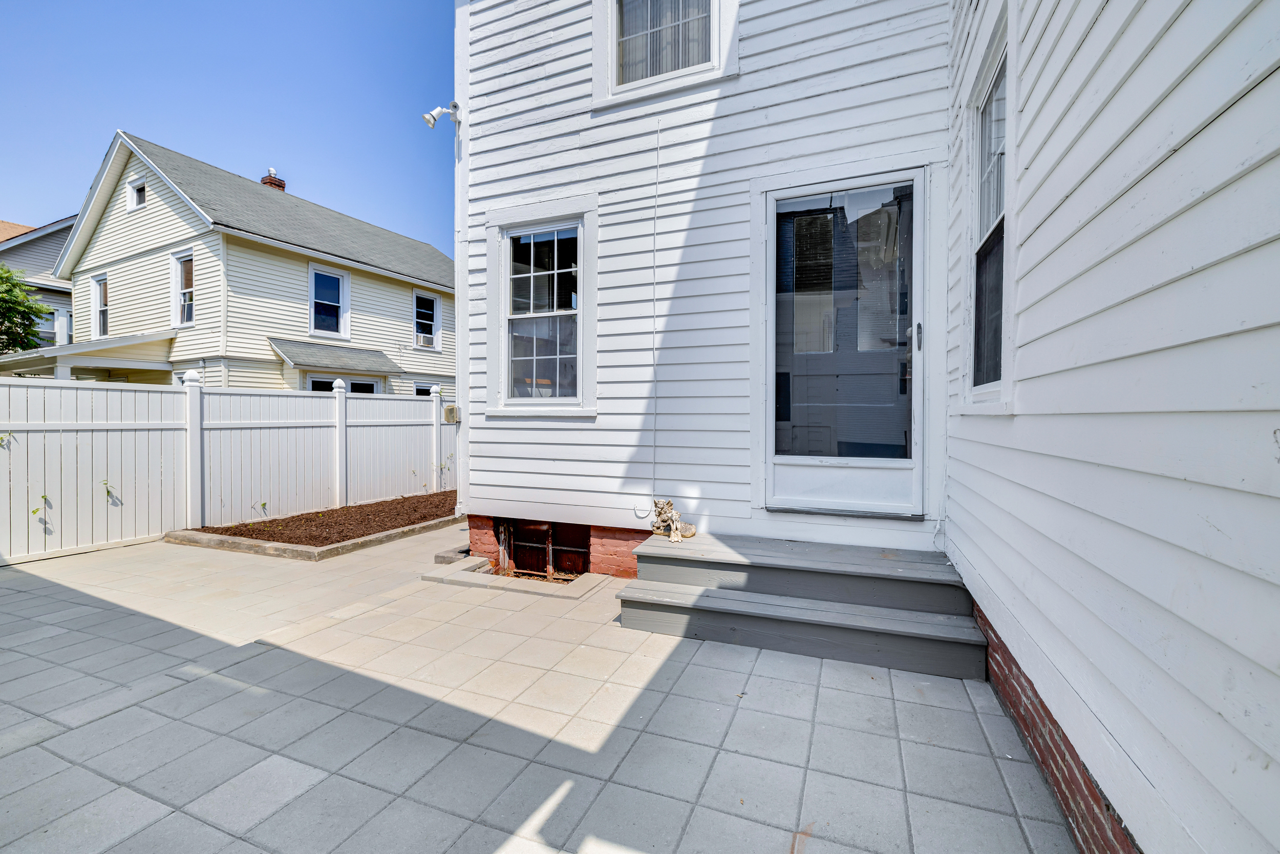 1070 Enfield Street Enfield, CT 06082 - Photo 34 of 35 a view of a white house with wooden fence