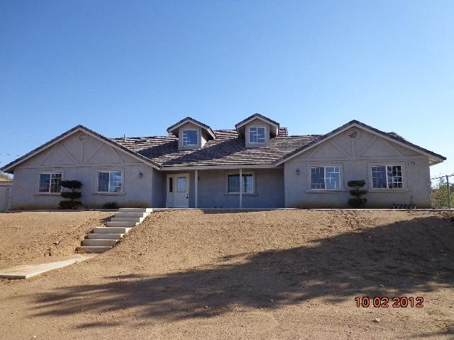 10637 Ranchero Road Oak Hills, CA 92344 - Photo 1 of 1 a front view of a house with a yard