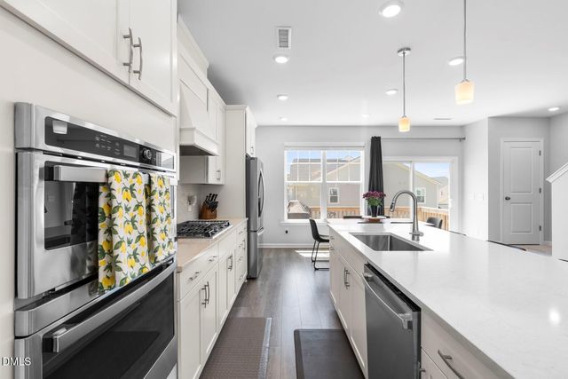a kitchen with a table and chairs in it