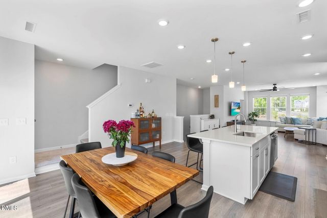 a kitchen with a sink a counter top space stainless steel appliances and cabinets