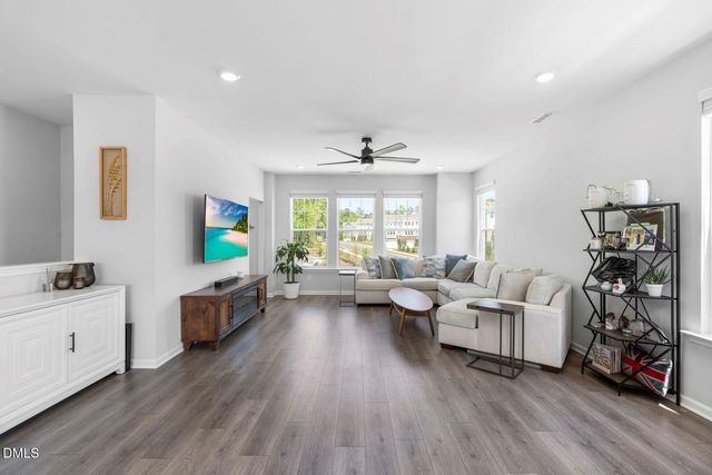 a view of a dining room with furniture and a kitchen