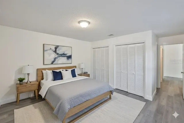 a bedroom with a bed and a painting on the wall