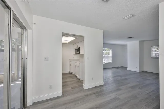 a view of empty room with wooden floor
