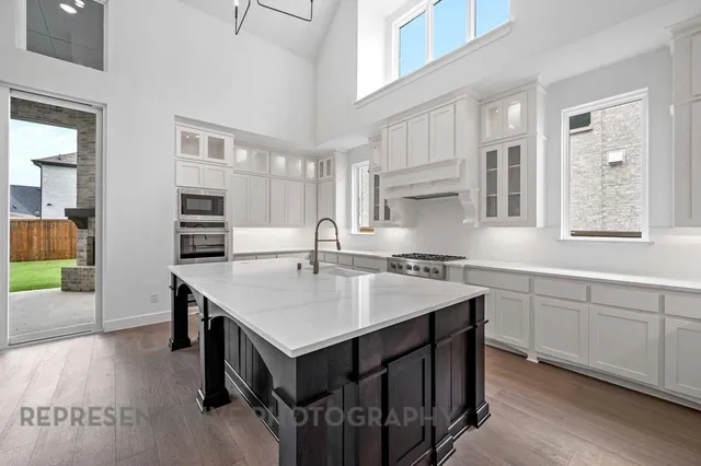 a kitchen with a stove a sink and a refrigerator