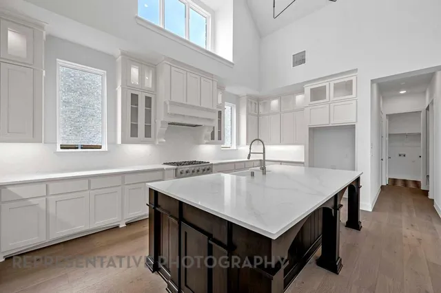 a kitchen that has a lot of counter space and wooden floor