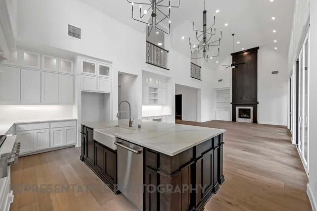 a kitchen that has a lot of cabinets and wooden floor