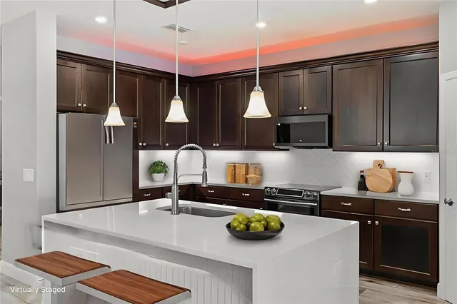 a kitchen with a sink a counter and cabinets