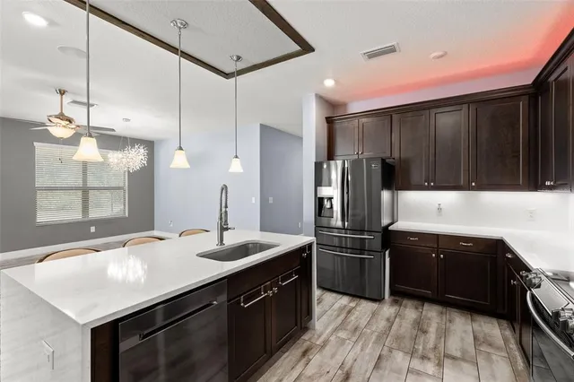a kitchen with stainless steel appliances a sink and a refrigerator