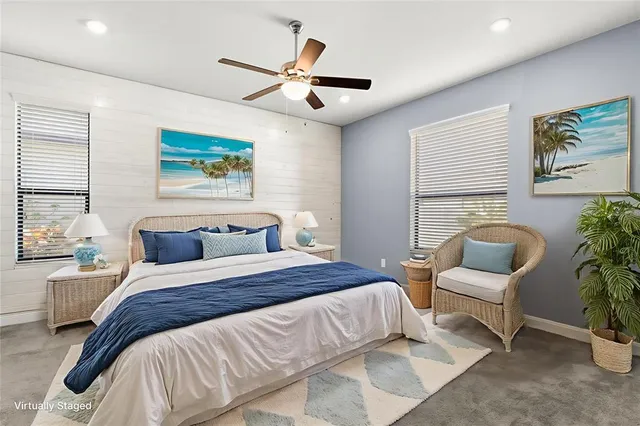 a bedroom with a large bed and a painting on the wall