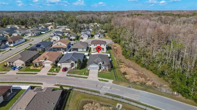 an aerial view of a house with a yard