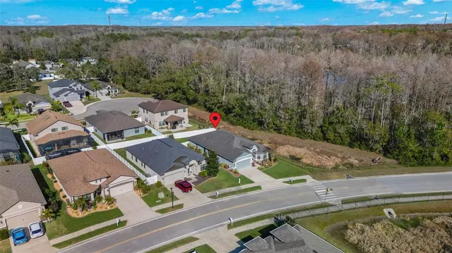 an aerial view of a house with a yard